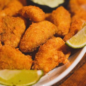 Delicious crispy fried seafood served with lime wedges and dipping sauce.
