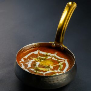 Rich and creamy dal makhani served hot in a traditional Indian pan. Perfect for food lovers.