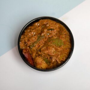 Top-down view of flavorful Indian vegetable curry in a black bowl