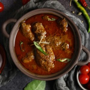 Aromatic Indian curry with meat and spices served in a traditional clay pot