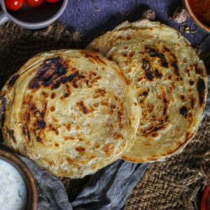 Delicious Indian parotta served with side dishes